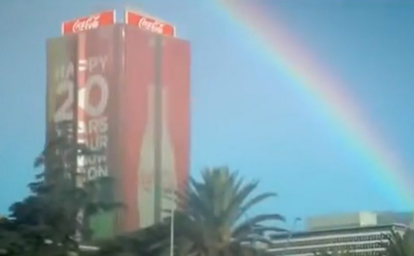 A ground-level rainbow appears on a Johannesburg street as part of Coca-Cola’s “Rainbow Nation” anniversary activation.