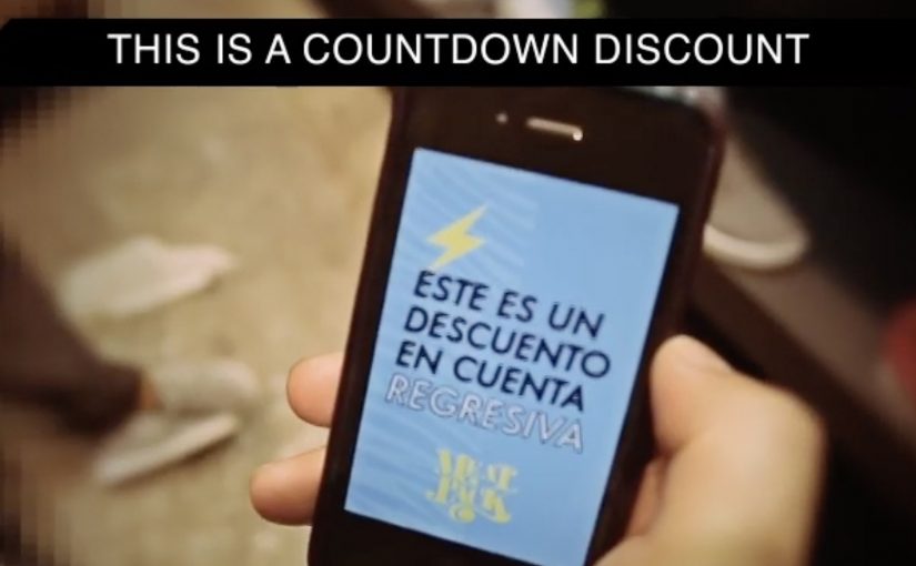 Countdown discount alert on a shopper’s phone inside a competitor shoe store.