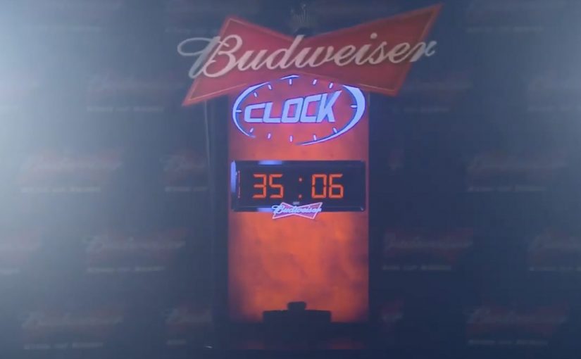 A Budweiser Budclock machine that extends happy hour when QR code coasters are scanned.