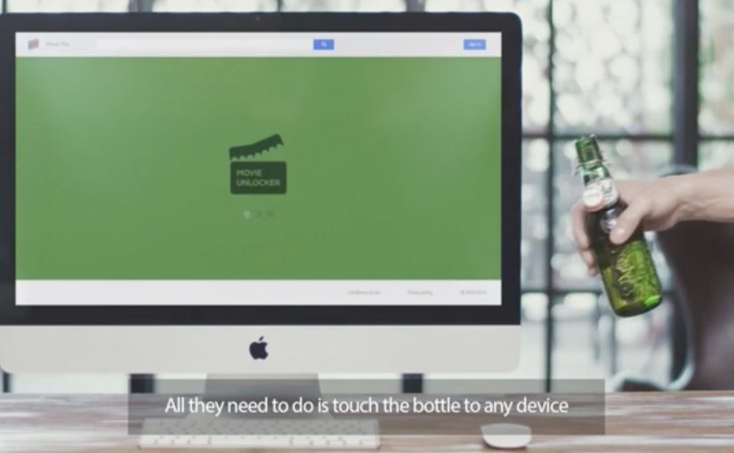 Grolsch beer bottle unlocking a movie on a laptop via Bluetooth.