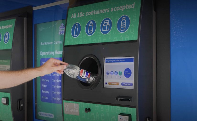 A Pepsi bottle being inserted into a Return and Earn reverse vending machine in New South Wales.