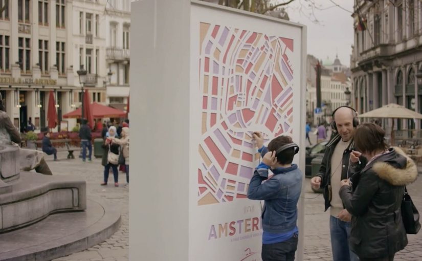 Interactive Thalys billboard inviting passersby to explore city sounds through plugged-in headphones.