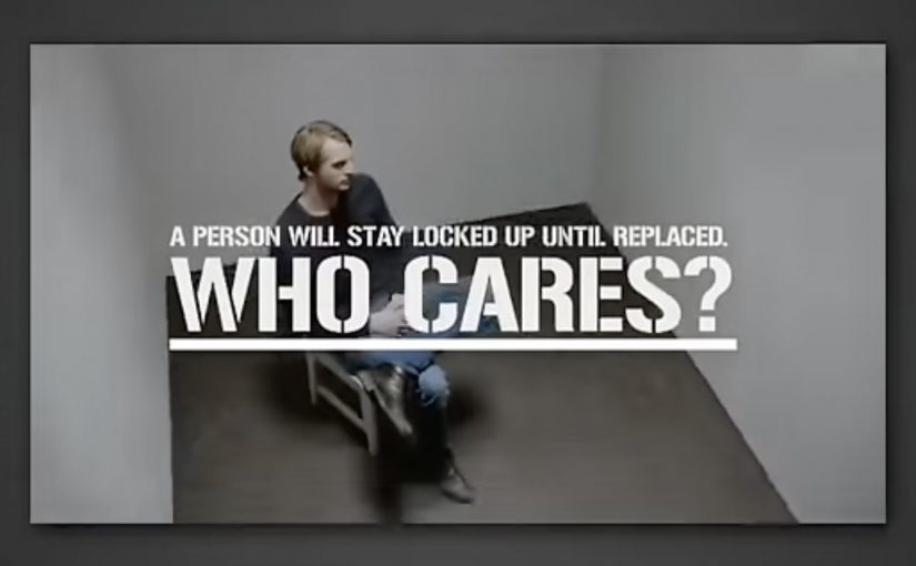 Still from the Swedish Armed Forces “Who Cares?” experiment showing a man locked in a bare room beside the message “A person will stay locked up until replaced.”