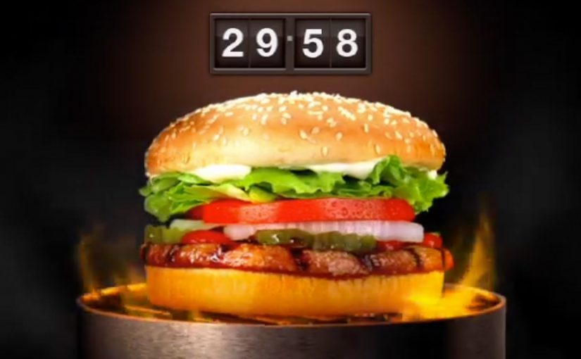 Rotating Whopper on a TV screen with countdown timer during Burger King’s Whopper Lust Challenge.